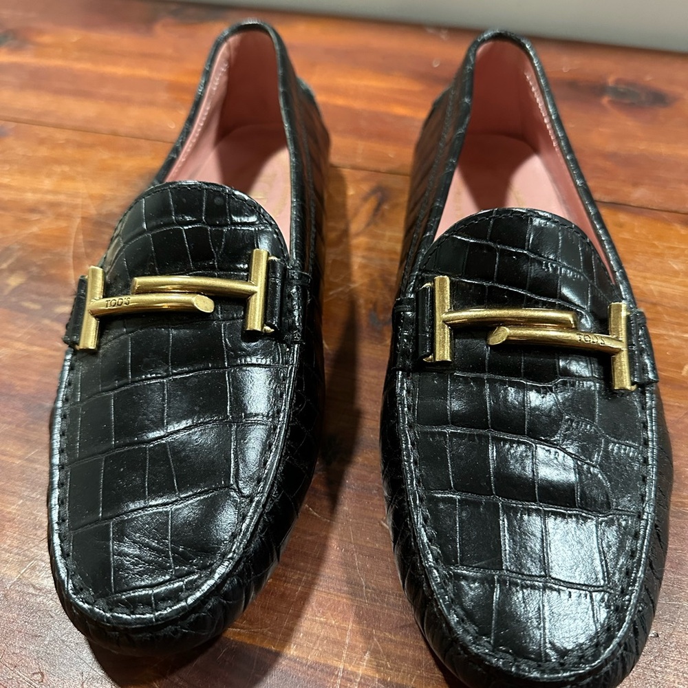 Tod's Black and Gold Leather Loafers with Embossed Pattern